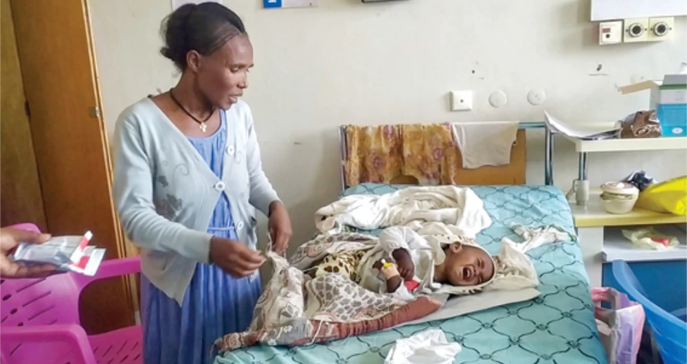 An unidentified mother and child are seen in the malnutrition ward at the Ayder Referral Hospital in Mekele, in the Tigray region of northern Ethiopia. (AP)
