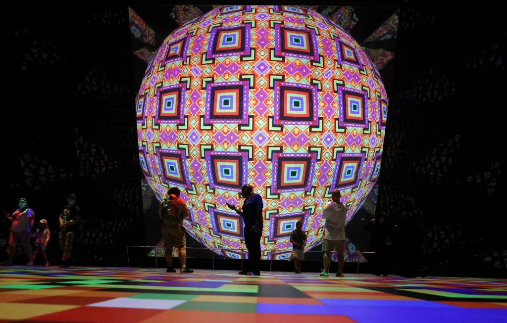 isitors stand in front of a display at the Saudi Arabia Pavilion of Expo 2020 (Getty)