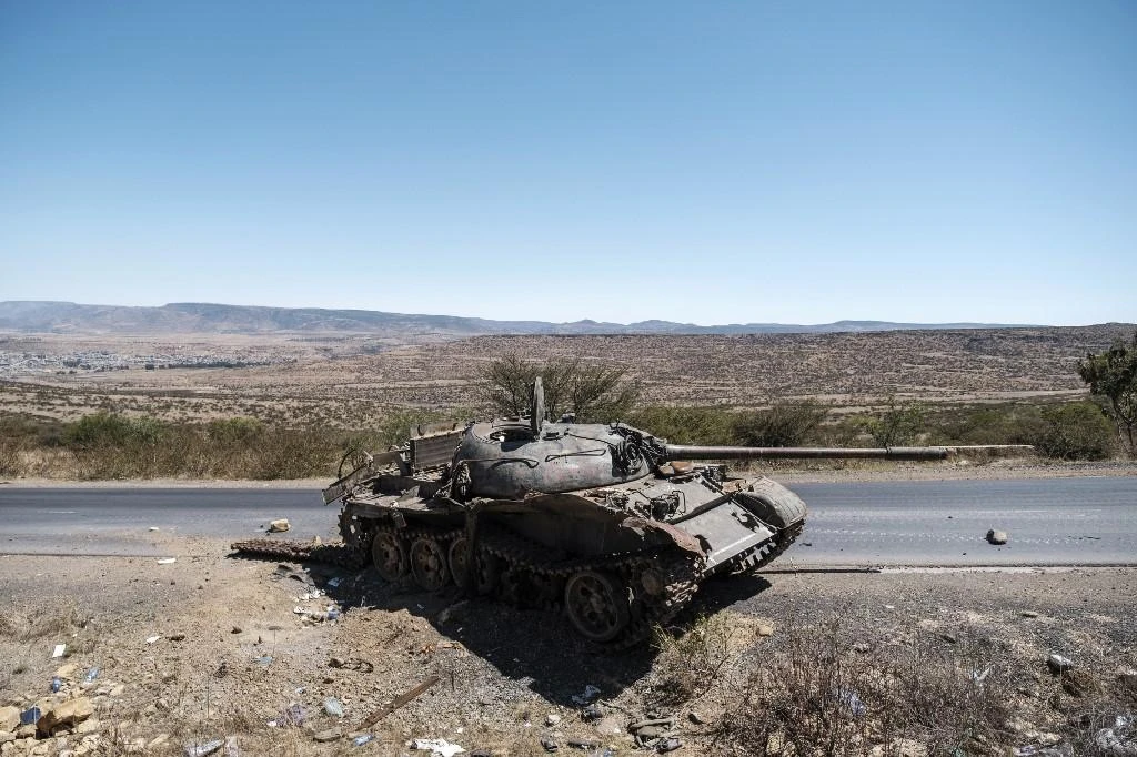 Above, a damaged tank stands on a road north of Mekele, the capital of Tigray. (AFP)