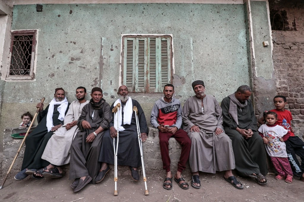 Egyptian men in the village of Al-Nehaya, one of the poorest in the country, in the province of Assiut, central Egypt. (AFP)