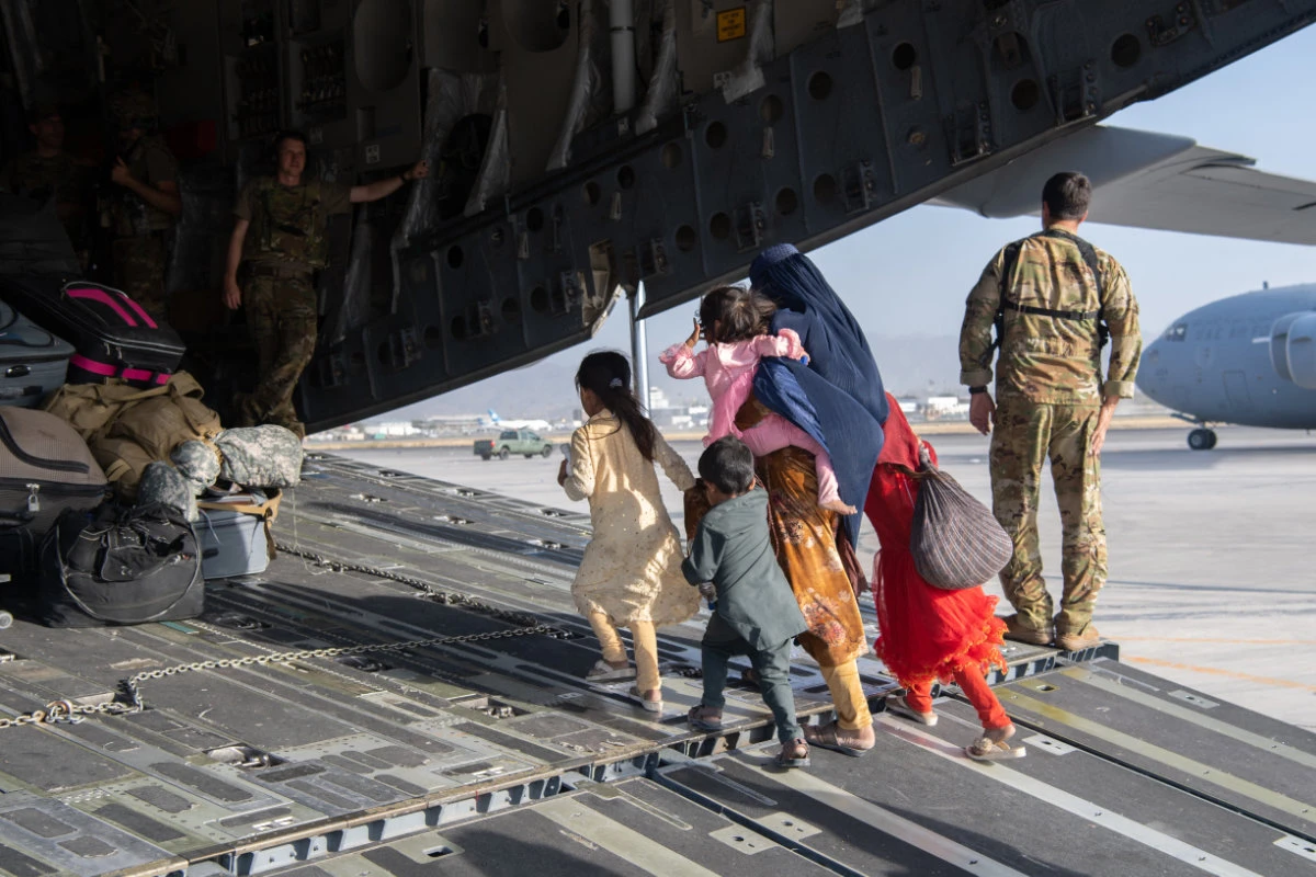 An Afghan family heads to freedom as part of a major airlift at Hamid Karzai International Airport in Kabul in August, 2021. (AFP)