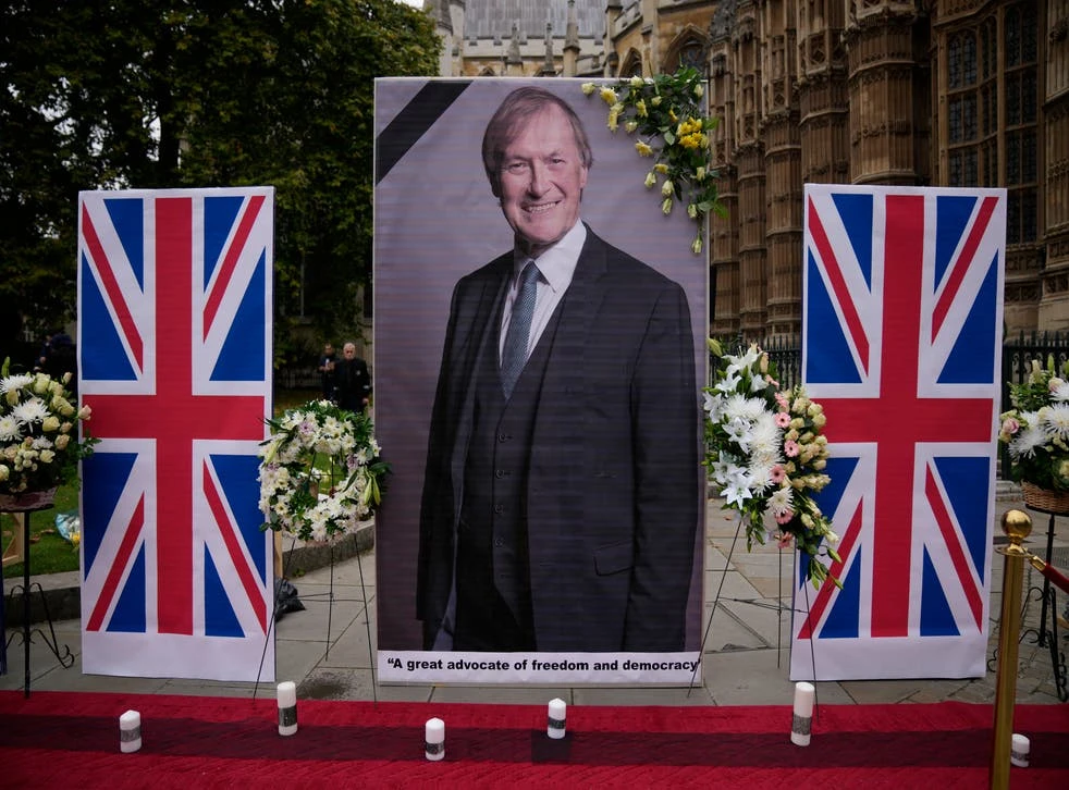 An image of Sir David Amess opposite the Houses of Parliament, placed in tribute to the MP who was killed during a constituency surgery. (AP Photo)