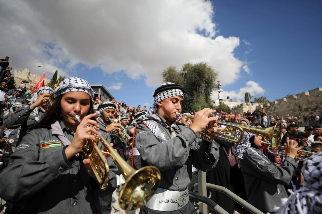 Palestinian scouts play music during a ceremony to celebrate Prophet Muhammad’s birth anniversary near Damascus Gate at Jerusalem’s Old City on Tuesday. (Reuters)