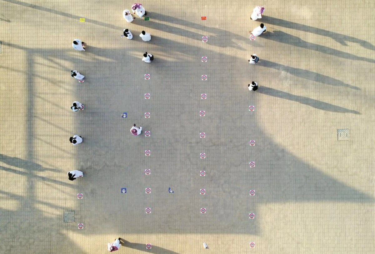 In this photo taken by a drone, students stand on social distancing markers at a school in Riyadh on Aug. 30. Reuters)