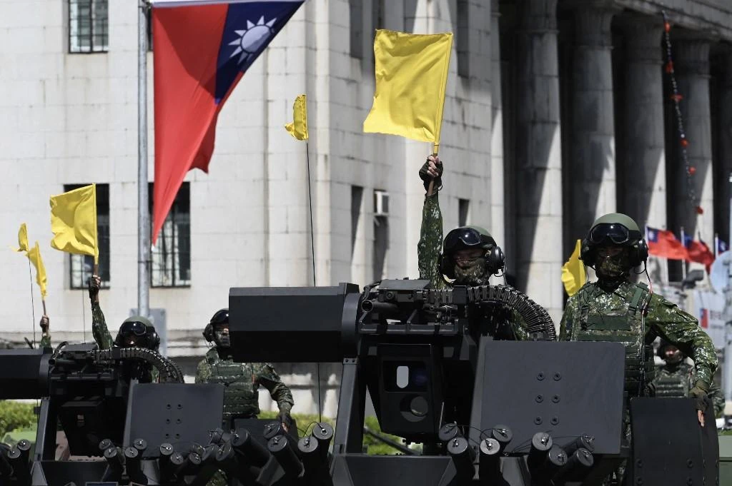 President Tsai Ing-wen said Taiwan would not be forced to bow to China. Above, soldiers aboard military vehicles during a national day parade on Oct. 10, 2021. (AFP)