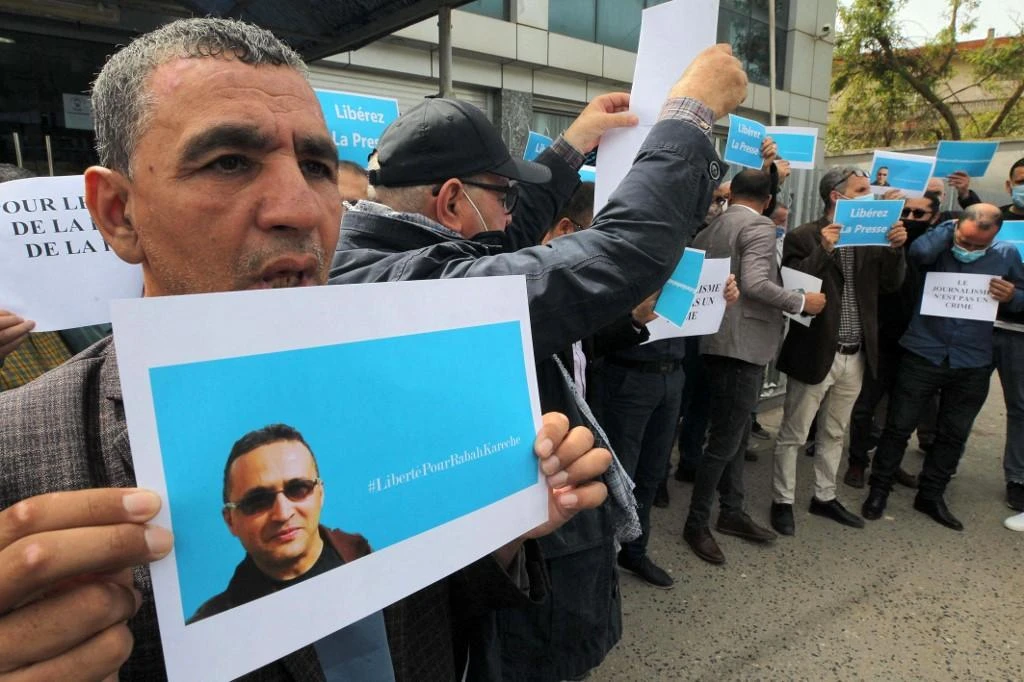 Supporters protest the detention of journalist Rabah Kareche in demonstration on April 25, 2021 in Algiers. (AFP)