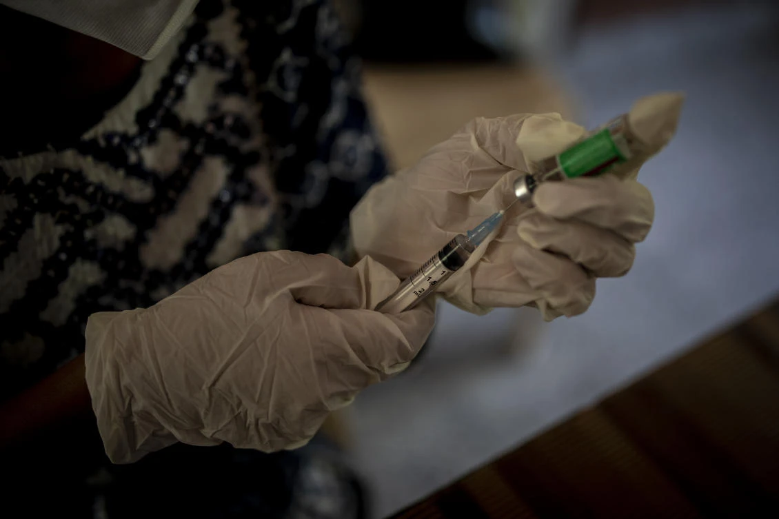 A health worker prepares to administer a COVID-19 dose inside a school in New Delhi, India, Wednesday, Oct. 20, 2021. India is nearing a milestone of administering a total of one billion doses against COVID-19. (AP)