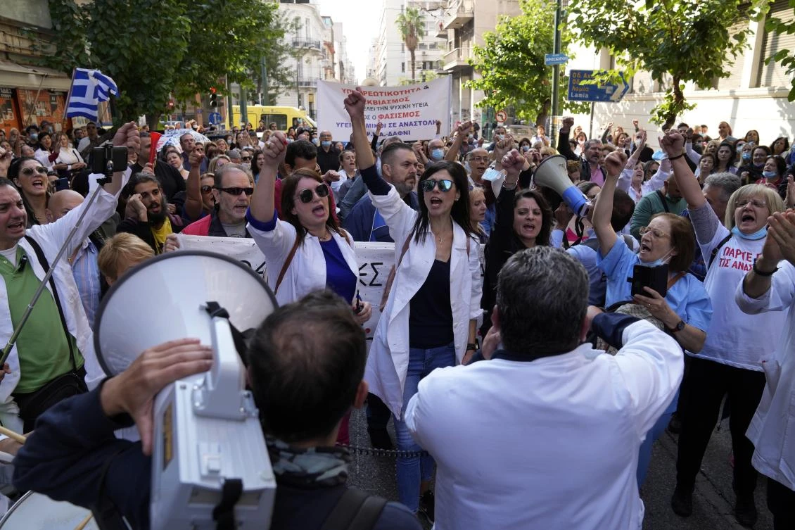 Hundreds of Greek state hospital workers marched through central Athens as part of a 24-hour strike to protest staff shortages and compulsory coronavirus vaccinations. (AP)