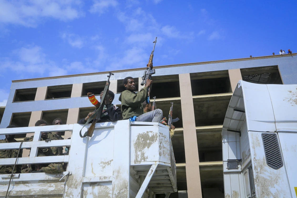 Armed Tigray forces, center, accompany captured Ethiopian government soldiers and allied militia members as they are paraded through the streets in open-top trucks, as are taken to a detention center in Mekele, Friday, Oct. 22, 2021. (AP Photo)