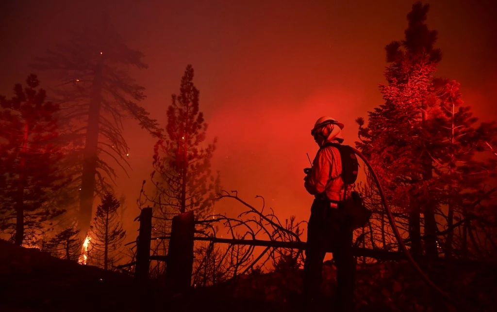 A firefighter watches as the Bobcat Fire burns near Cedar Springs in the Angeles National Forest on Sept. 21, 2020 in Los Angeles, California. (File/AFP)