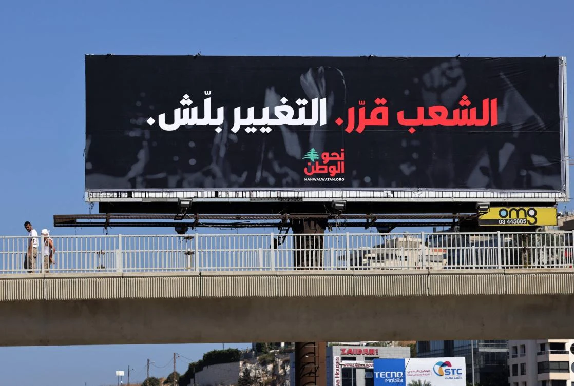 An electoral billboard that reads in Arabic “The people has decided, the change has started” is put up in Dbayeh, eastern Beirut. (AFP)