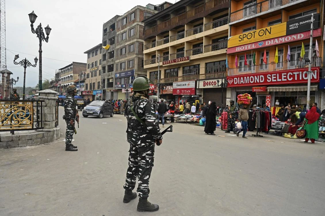 Indian paramilitary troopers stand guard at a market in Srinagar on October 24, 2021. (AFP)