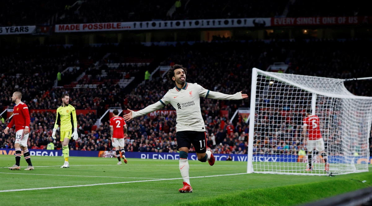 Liverpool's Egyptian midfielder Mohamed Salah celebrates after scoring their fifth goal, his third during a match between Manchester United and Liverpool. (AFP)
