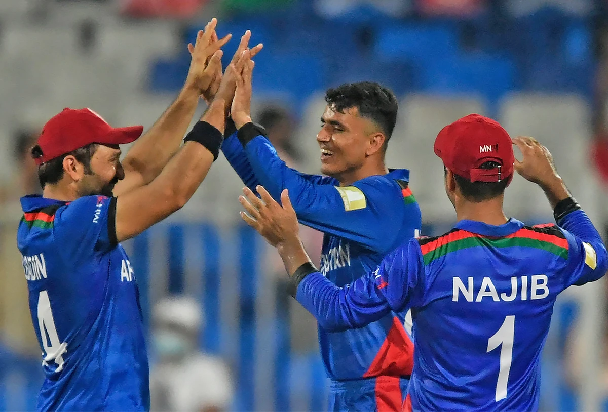 Afghanistan's players celebrate the dismissal of Scotland's Mark Watt (not pictured) during Twenty20 World Cup cricket match between Afghanistan and Scotland in Sharjah on October 25, 2021. (AFP)