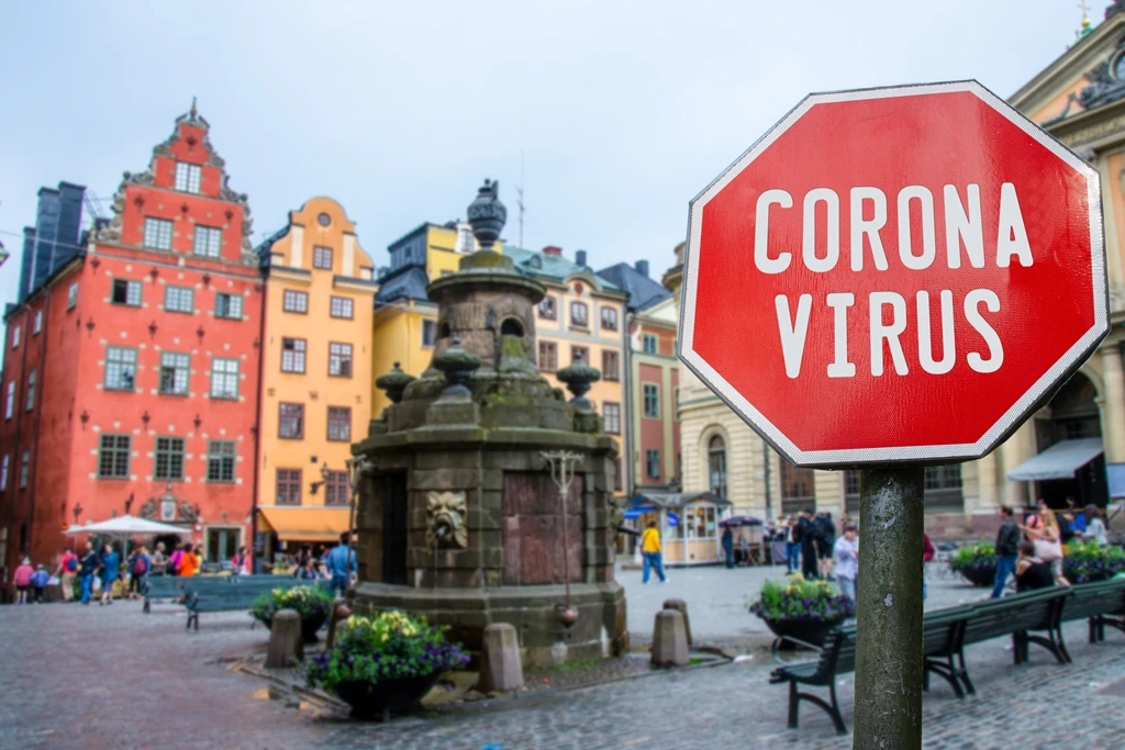 A coronavirus stop sign with view of historic old town in Stockholm warning about epidemic quarantine. (Shutterstock)