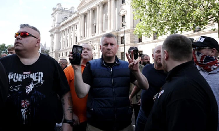 The Britain First hotel visits are sometimes fronted by the organisation’s leader, Paul Golding, center. (Getty Images)