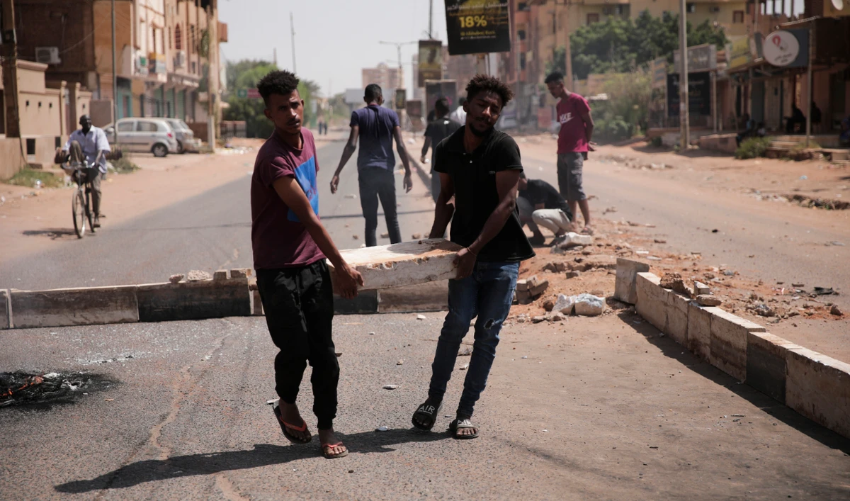 Sudanese man protest against a military coup that overthrew the transition to civilian rule, on October 25, 2021 in the Al-Shajjara district in southern Khartoum. (AP)