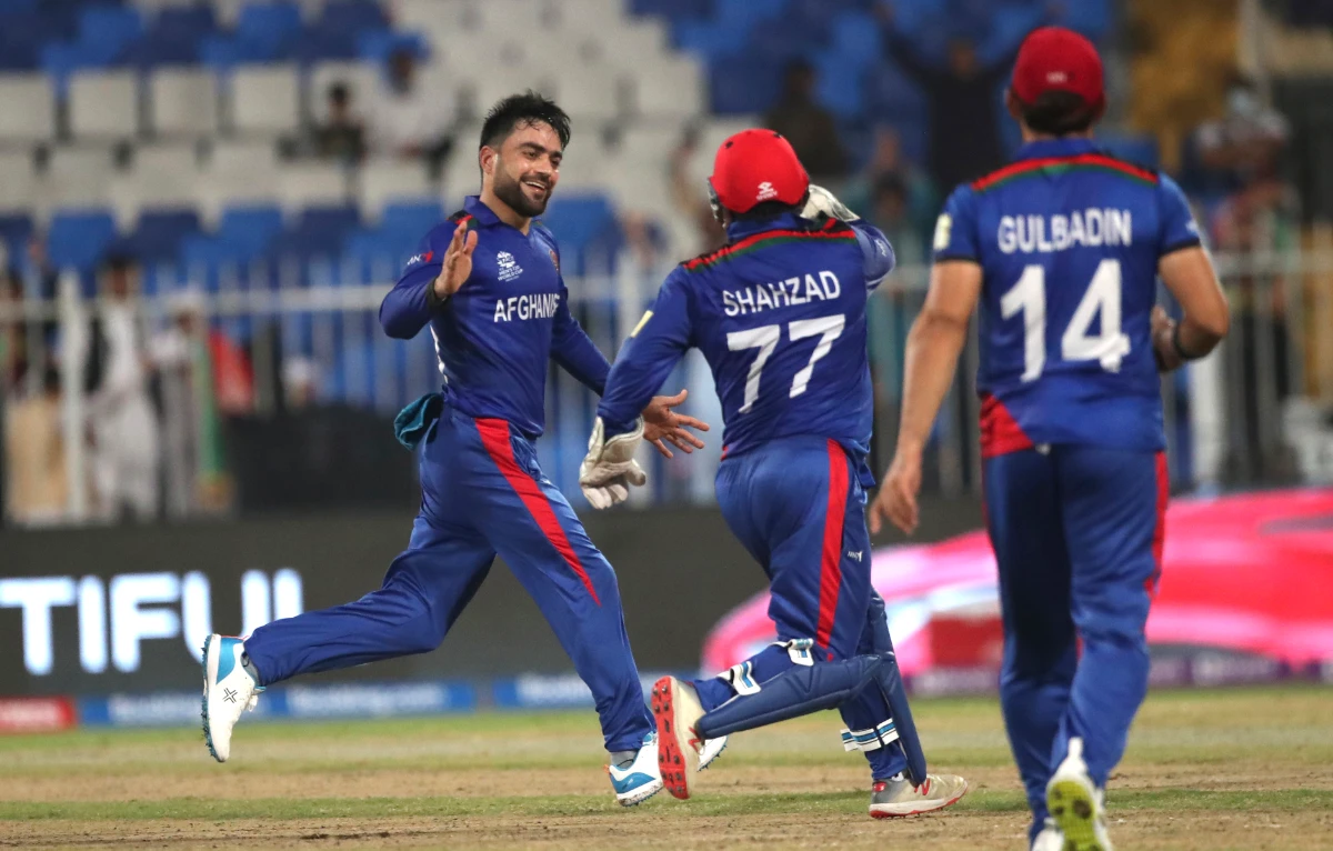 Afghanistan's Rashid Khan celebrates the wicket of Scotland's Brad Wheal during the Cricket Twenty20 World Cup match between Afghanistan and Scotland in Sharjah, UAE, Monday, Oct. 25, 2021. (AP)