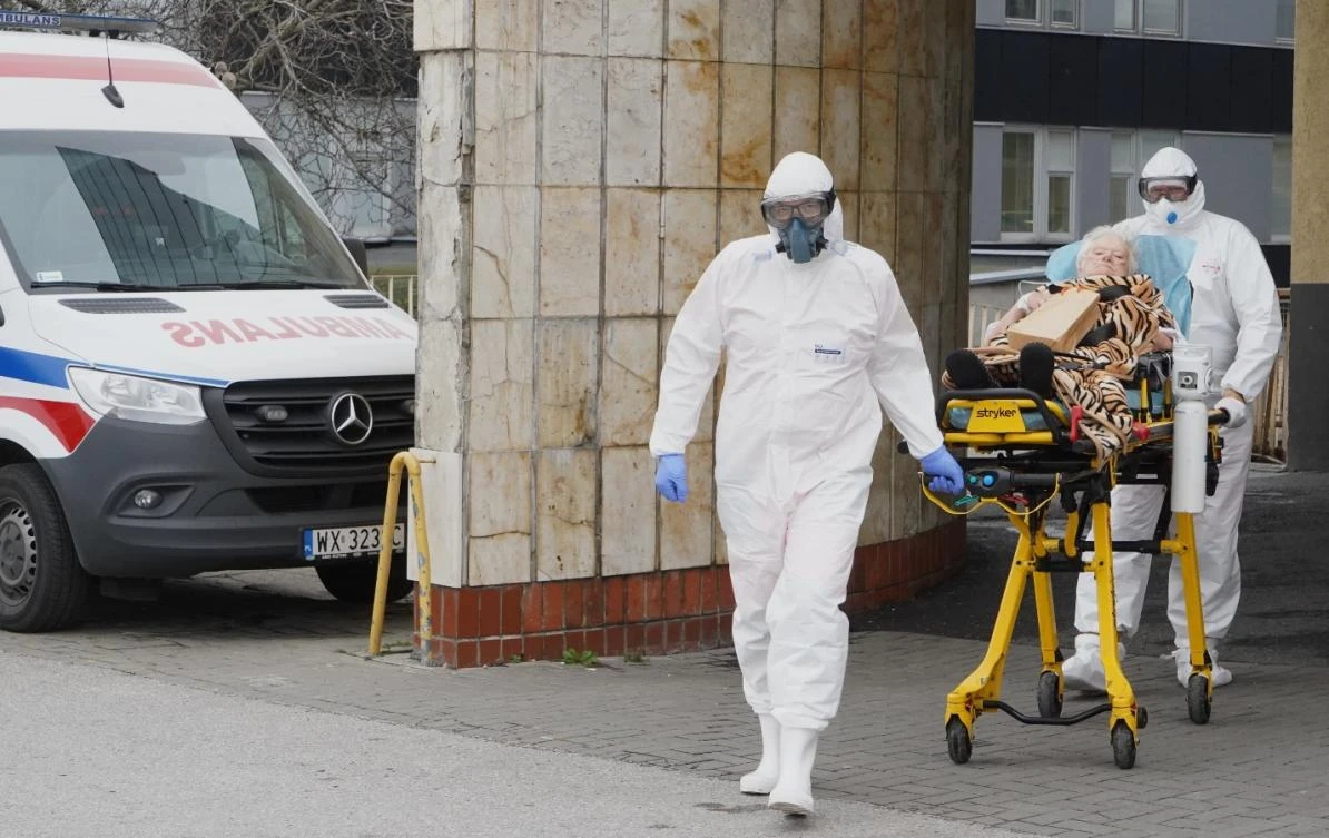 Two ambulance workers in protective suits transport a coronavirus COVID-19 infected patient to a hospital in Warsaw, Poland, on November 7, 2020. (File/AFP)