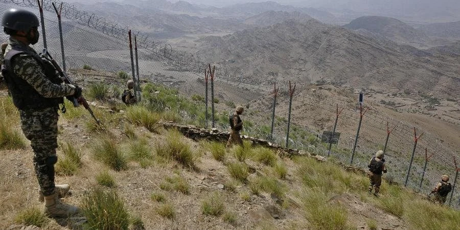 File photo showing Pakistan Army troops patrol along the fence on the Pakistan Afghanistan border at Big Ben hilltop post in Khyber district. (AP)
