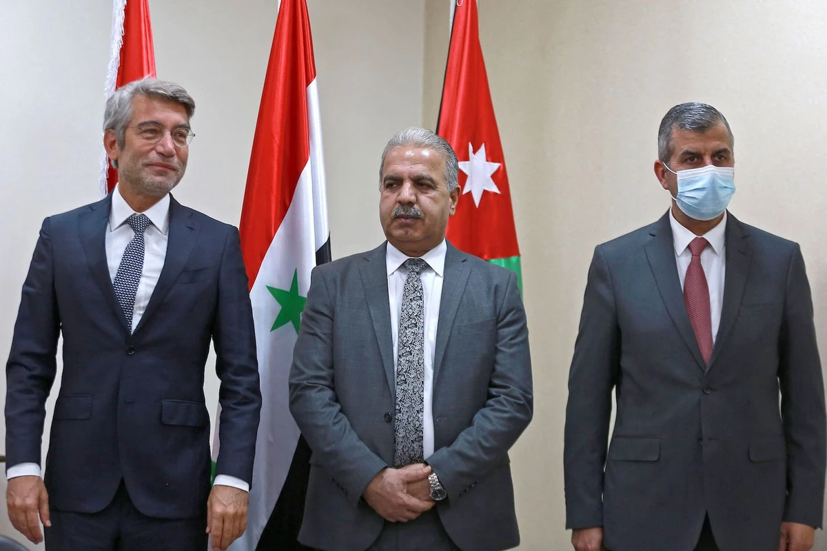 Jordan's Minister of Energy Saleh al-Kharbasha (R) receives his counterparts from Syria Bassam Tohme (C) and from Lebanon Walid Fayad during a meeting in Amman on October 28, 2021. (AFP)