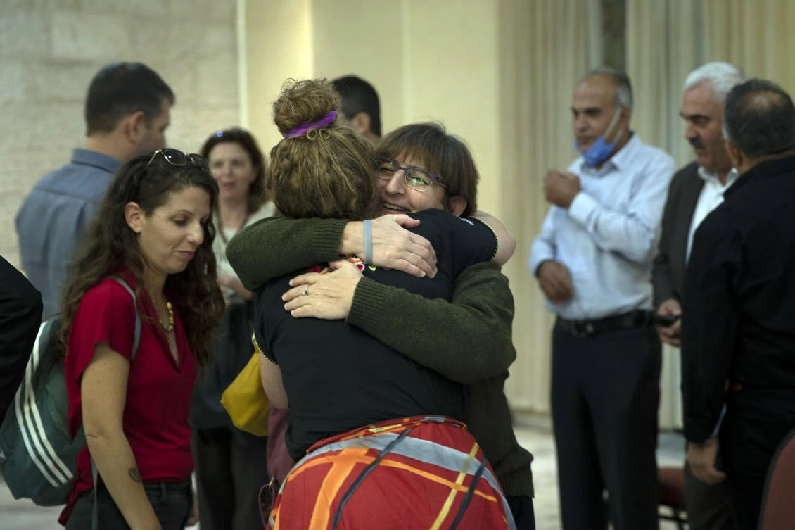 Sahar Francis, director of Addameer, a Palestinian prisoner rights group, welcomes representatives of Israeli human rights organizations in the West Bank city of Ramallah, Oct. 27, 2021. (AP Photo)