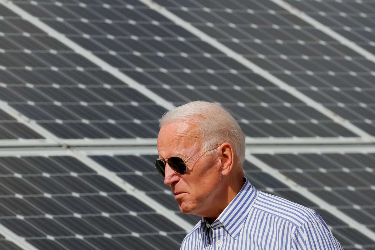 Joe Biden walks past solar panels while touring the Plymouth Area Renewable Energy Initiative in Plymouth, New Hampshire, U.S., June 4, 2019. (Reuters)
