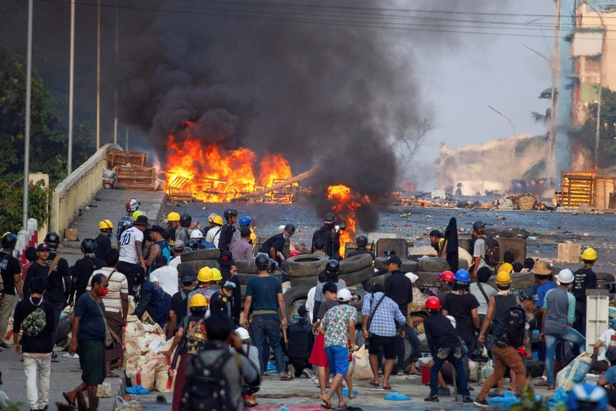 Anti-coup protesters man a barricade as they clash with security forces on Bayint Naung Bridge, Mayangone, Yangon, Myanmar, Mar. 16, 2021. (Reuters)