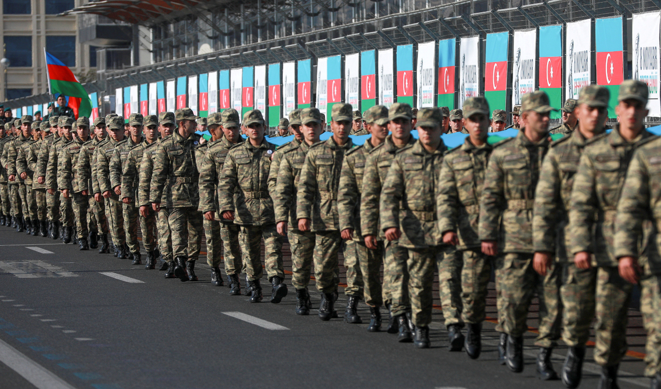 Azeri service members take part in a procession marking the anniversary of the end of the 2020 military conflict over Nagorno-Karabakh breakaway region, involving Azerbaijan's troops against ethnic Armenian forces, in Baku, Azerbaijan. (Reuters/File)