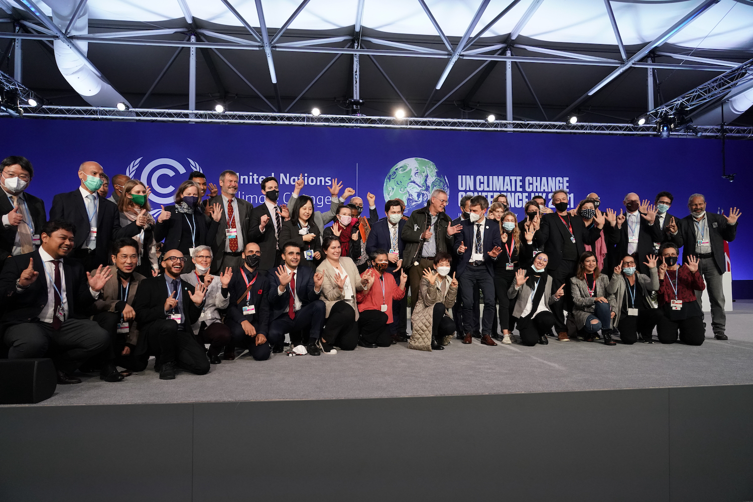 Delegates from different countries pose for a group photo at COP26 UN Climate Summit, in Glasgow, Scotland on Nov. 13, 2021. (AP)