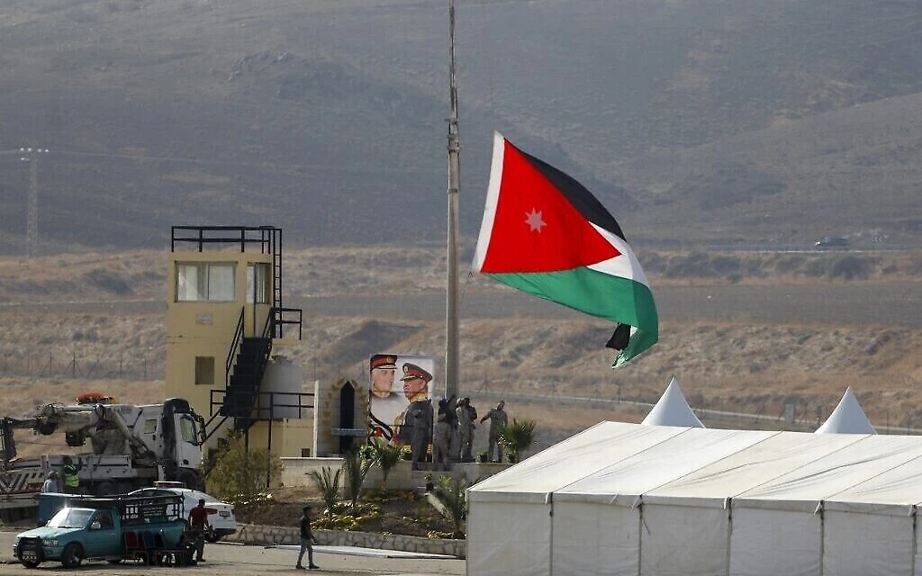 Jordanian soldiers raise the national flag at Naharayim, near the border with Israel, Nov. 10, 2019. (AFP)