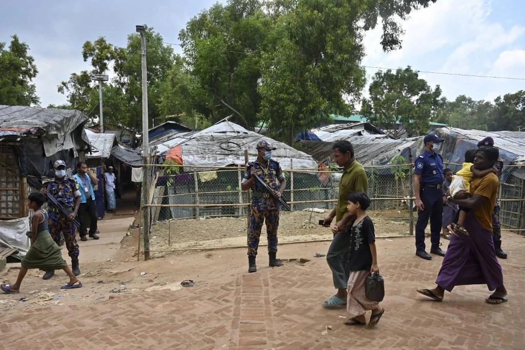Law enforcement officials stand guard near the office of slain community Rohingya leader Mohib Ullah, who was shot dead by gunmen at Kutupalong refugee camp in Ukhia on Oct. 6, 2021. (AFP)