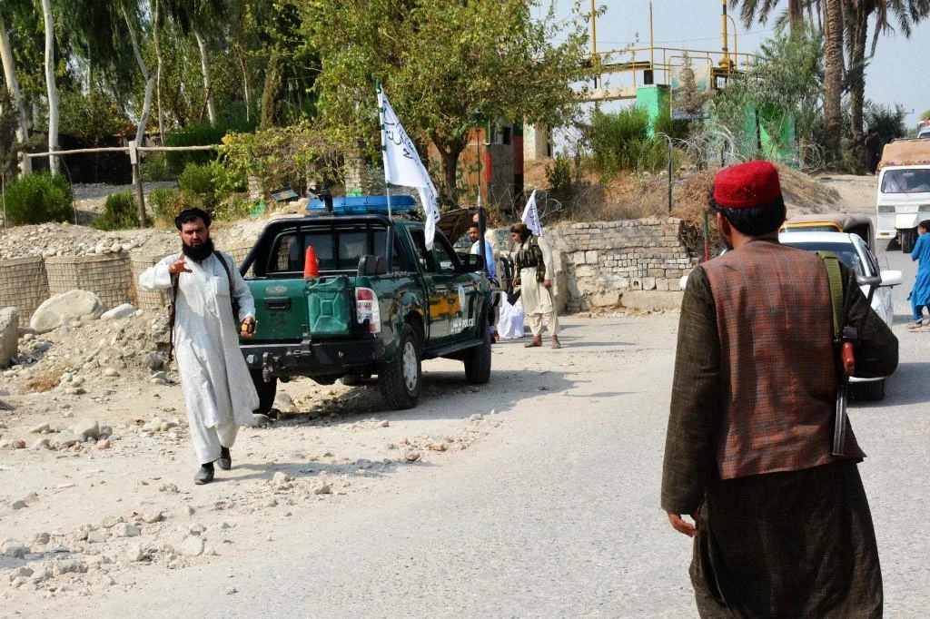 Taliban members inspect near the site of a blast in Jalalabad earlier on Sept. 18, 2021. A roadside bomb on Wednesday killed two people and wounded three others, witnesses said. (AFP)