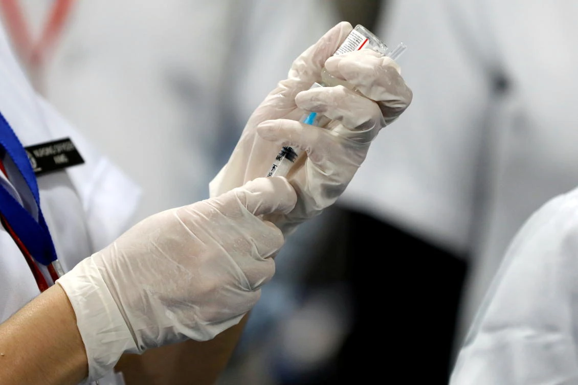 A health care worker fills a syringe with a dose of Bharat Biotech’s COVID-19 vaccine called COVAXIN, during the vaccination campaign at All India Institute of Medical Sciences hospital in New Delhi. (Reuters)