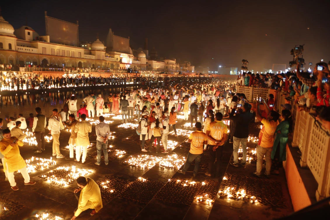 People light lamps on the banks of the river Saryu in Ayodhya, India, Wednesday, Nov. 3, 2021. (AP)