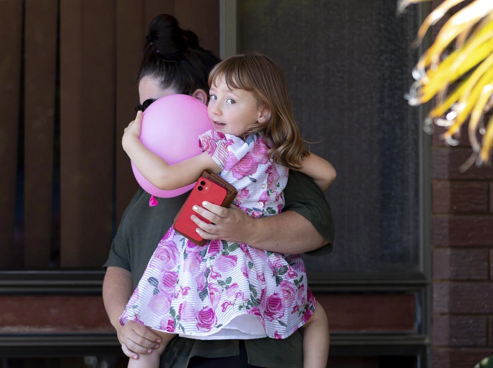 Cleo Smith, right, and her mother Ellie Smith leave a house where they spent the night after 4-year-old Cleo was rescued in Carnarvon, Australia. (AAP Image via AP)