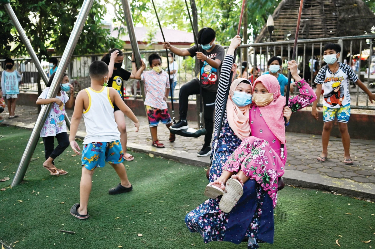 Children enjoy themselves at a public park, as the country’s capital region loosens coronavirus disease (COVID-19) restrictions, in Quezon City, Metro Manila. (Reuters)