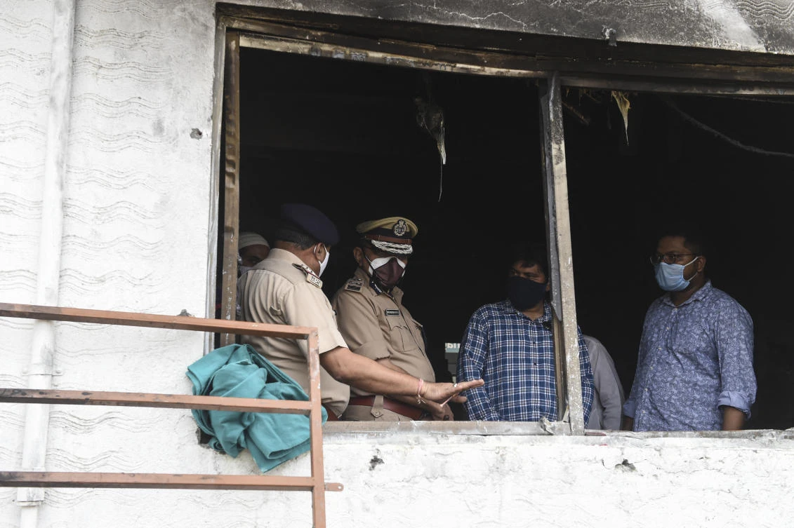 Vadodara Range IG, Harekrishna Patel (2L) insopects the Patel Welfare Covid Hospital after a fire broke out overnight killing 16 Covid-19 patients. (File/AFP)