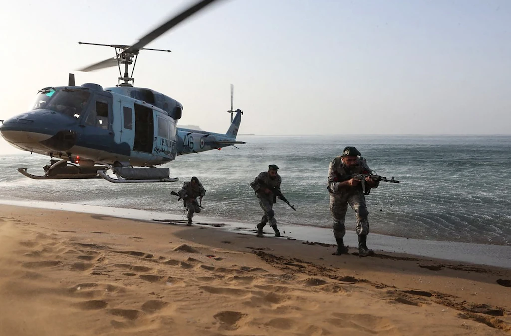 This handout image provided by the Iranian Army Office on November 7, 2021, shows Iranian soldiers participating in a military exercise on the shore of the southern Iranian Makran sea, is the coastal region of Baluchistan. (AFP)