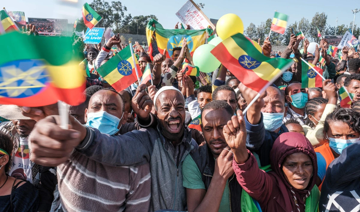 Demonstrators wave flags during a rally in Addis Ababa where they dismissed diplomatic efforts to end the conflict in support of the national defense forces. (AFP)