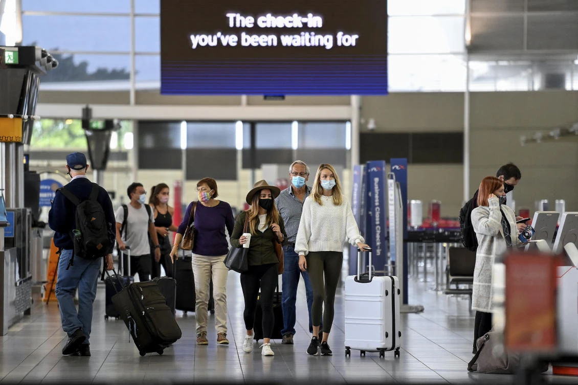 Australia’s border opened last week for the first time in 20 months. Above, passengers wear face masks as they arrive at Sydney Domestic Airport on Nov. 5, 2021. (AAP Image via AP)