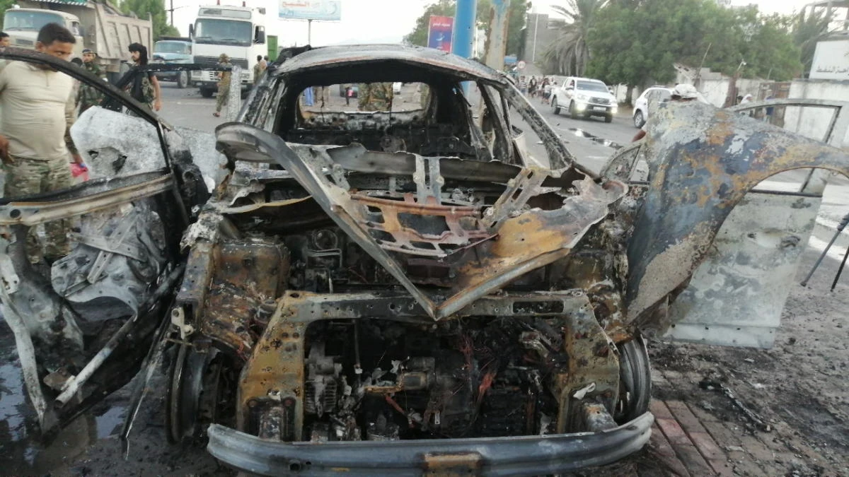 A security man inspects the wreckage of a car at the site of an explosion that killed a journalist in Aden, Yemen on Tuesday. (Reuters)