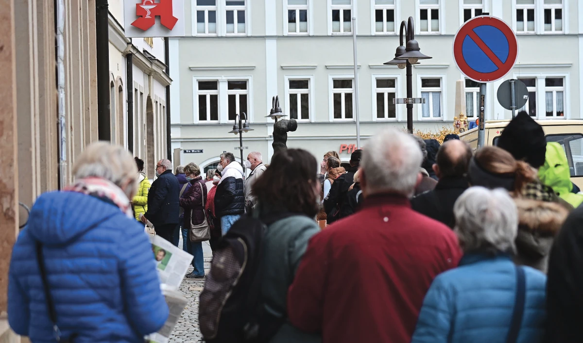 People queue in front of a vaccination center in Radeberg, eastern Germany, to get a COVID vaccination without an appointment. (AFP)