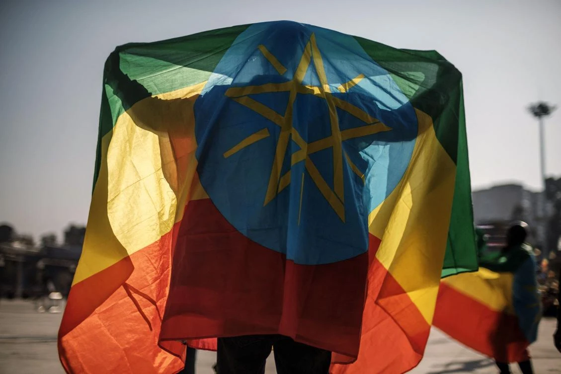 In this file photo taken on November 07, 2021 A man covers himself with an Ethiopian flag during a rally in Addis Ababa, Ethiopia, in support of the national defense forces. (AFP)