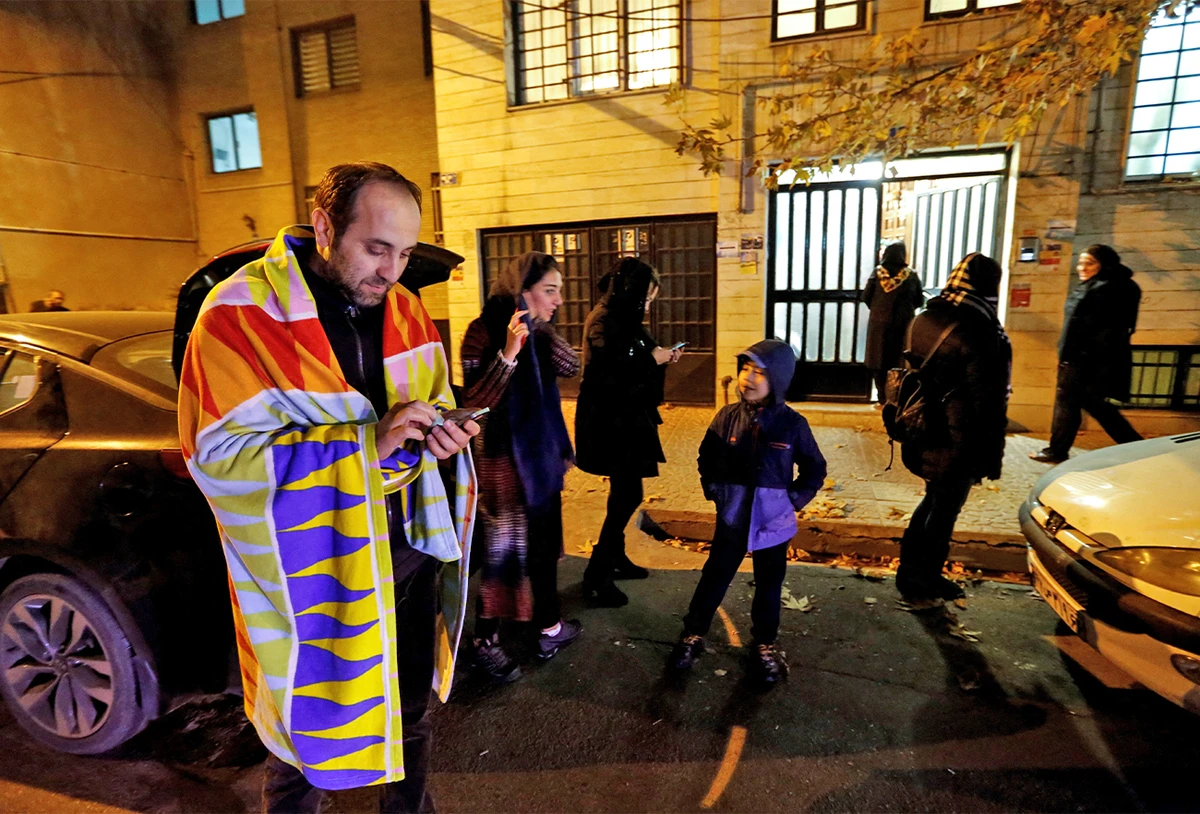 People leave their houses and wait in the streets in Tehran overnight on December 21, 2017, after an earthquake was felt in the Iranian capital. (AFP/File)
