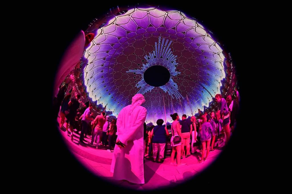 People attend a show at the al-Wasl hall of the Expo 2020, in the Gulf emirate of Dubai, on November 12, 2021. (AFP)