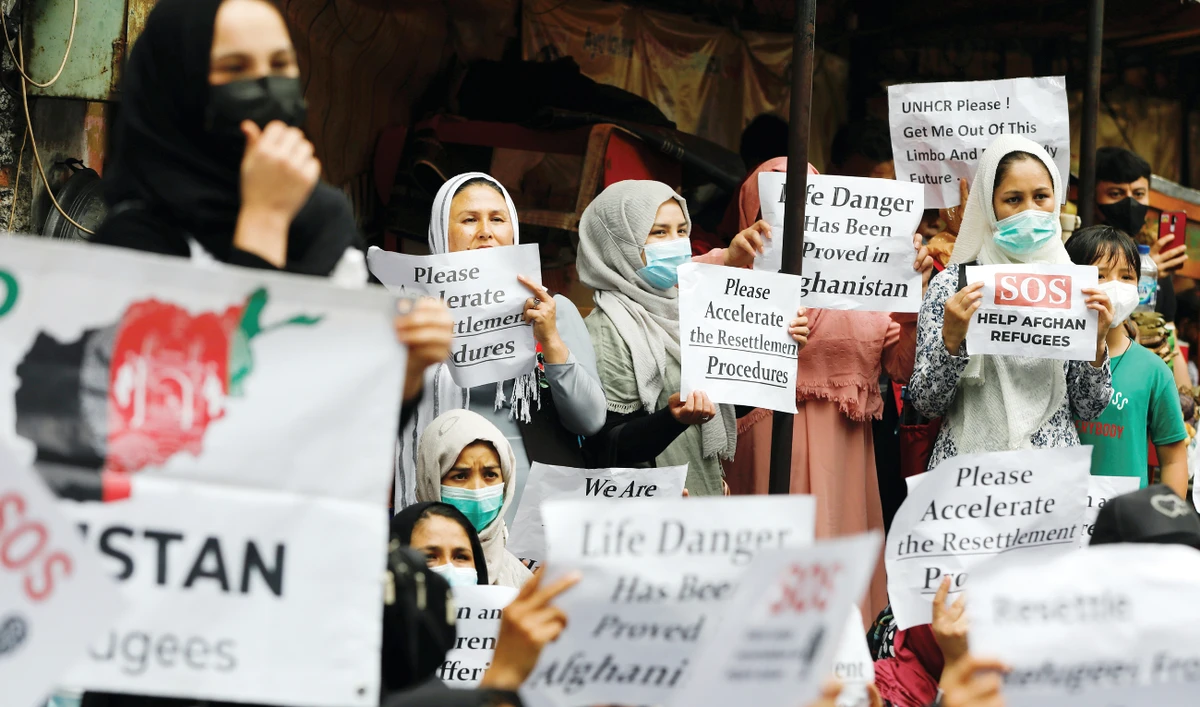 Afghan refugees, demanding acceleration of their resettlement to a third country, during a rally outside the UN Refugee Agency UNHCR’s office in Jakarta. (Reuters)