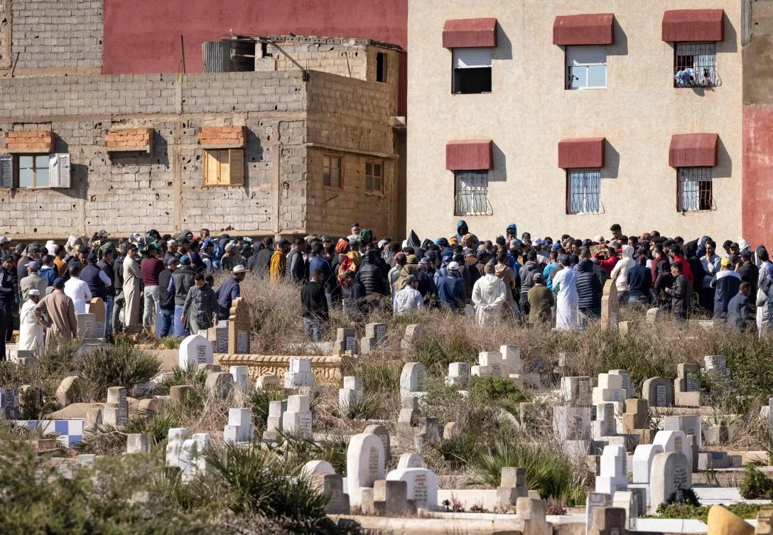 Moroccan mourners attend the funeral of migrants who died after a boat carrying Moroccan migrants capsized during a bid to reach Europe by sea on Friday. (AFP)