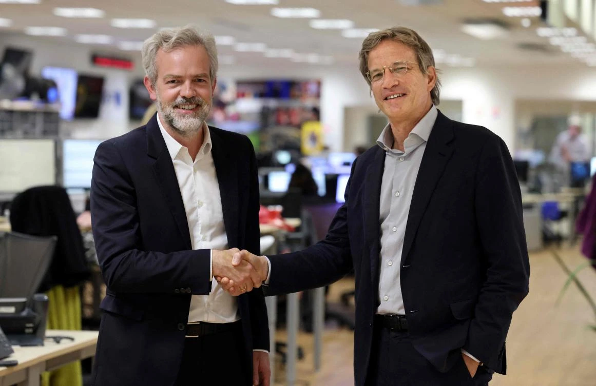 French CEO of AFP Fabrice Fries (R) poses with Google Vice president and Managing Director France Sebastien Missoffe at the AFP headquarters in Paris. (AFP)