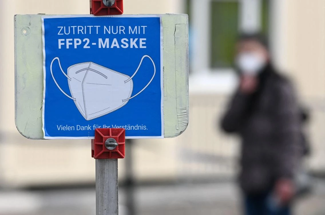 A sign informs people to cover mouth and nose with an FFP2 mask in front of a Covid-19 pandemic test center near Munich on Thursday amid the ongoing pandemic. (AFP)